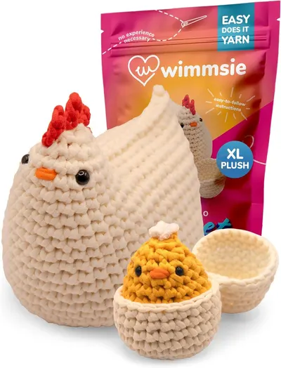 Shows all items included in the craft kit: the finished plush chicken, baby chick, egg basket, and packaging to demonstrate what the buyer will receive. Displays the product with its retail…
