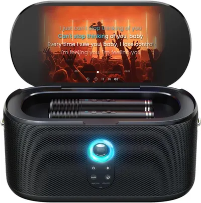 Shows the buyer exactly what is included in the purchase: the karaoke speaker system with built-in screen and two wireless microphones stored in the device.