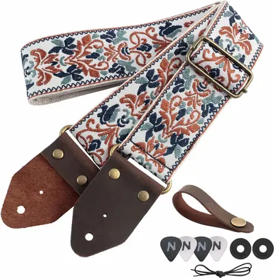 Shows the guitar strap along with all included accessories such as leather ends, picks, washers, and laces to communicate the complete value of the purchase.
