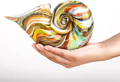 Showcases the colorful, artistic glass sculpture as the core product, emphasizing its unique handcrafted design and visual appeal. Uses a human hand to demonstrate the size and scale of the glass…