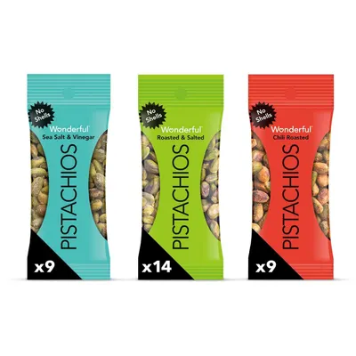 Shows the core product packages in three flavor variants to communicate the variety and convenience of the pistachio snack packs, emphasizing the no-shells benefit. Displays three distinct flavor…