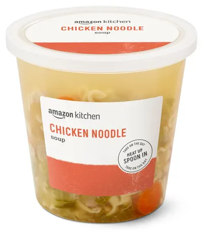 Shows the core product clearly with visible contents through the container to communicate freshness and quality of the chicken noodle soup. Displays the actual retail packaging the customer will…