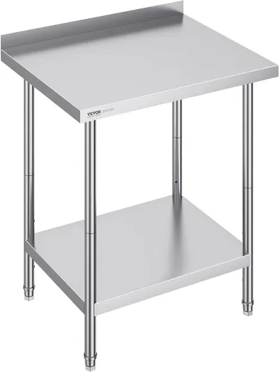 Displays the core product clearly in a catalog-style presentation to show the stainless steel work table's construction, two-tier design, and backsplash feature for commercial or home kitchen use.