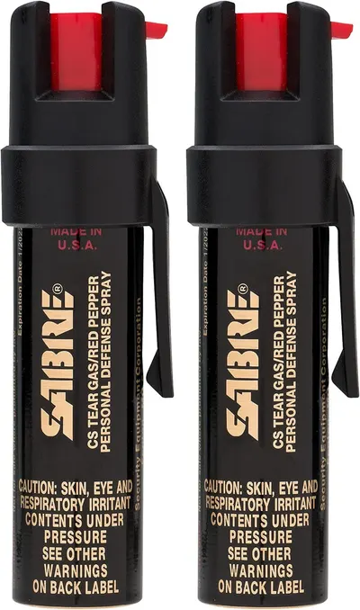 Shows two units of the SABRE pepper spray product clearly on a white background, communicating that this is a multi-pack purchase and displaying the product's branding and key features.
