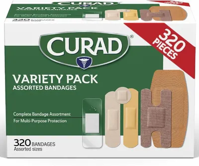 Shows the retail packaging of a Curad bandage variety pack containing 320 assorted bandages in multiple sizes and types, communicating the comprehensive assortment and value to shoppers looking for…