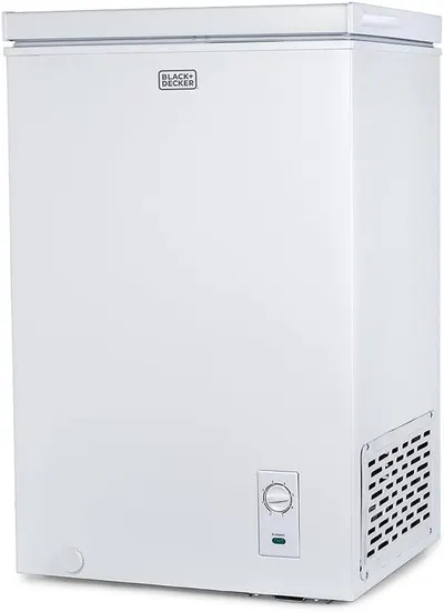 Displays the BLACK+DECKER chest freezer clearly on a white background to show the product's design, brand, and key features like the control dial and ventilation grille.