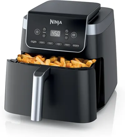 Shows the air fryer actively in use with cooked french fries in the pulled-out basket, demonstrating the product's cooking function and the type of food it can prepare to help shoppers visualize…