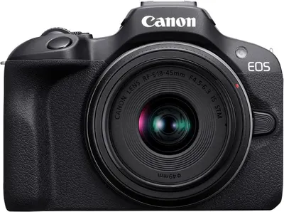 Displays the Canon EOS camera with attached lens in a clean, catalog-style presentation to show the product clearly and allow shoppers to see the design, branding, and key features of the camera…