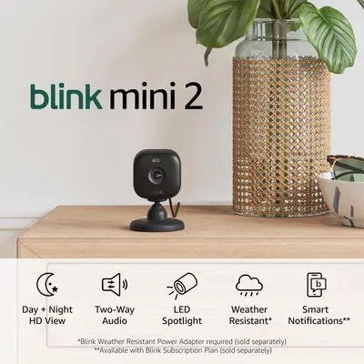 Shows the Blink Mini 2 camera in a real home environment to help shoppers visualize how the compact camera fits naturally into their living space. Communicates key product features through graphic…