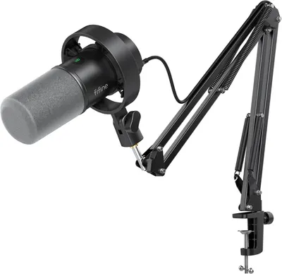 Shows the complete sellable product including the microphone with shock mount and adjustable boom arm stand to communicate what the buyer receives and how it's configured for use. Displays all…
