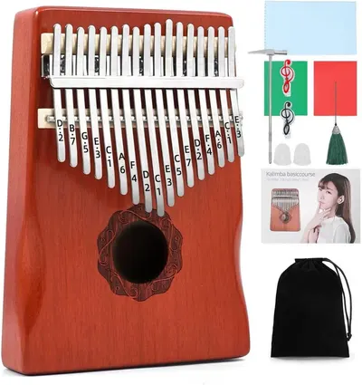 Shows the core kalimba instrument with all included accessories to communicate the complete package the buyer will receive. Displays all the bonus accessories included with the kalimba purchase such…