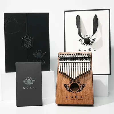 Displays the core sellable product, a wooden kalimba thumb piano with clear branding and craftsmanship details to show shoppers exactly what they will receive. Shows the premium retail packaging…