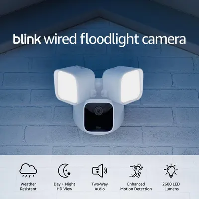 Shows the floodlight camera mounted in a real-world outdoor setting on a house exterior to help shoppers visualize how it will look installed at their home. Demonstrates the product's key functional…