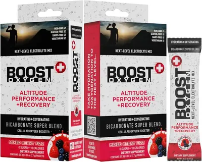 Displays the core product packaging clearly showing the Boost Oxygen electrolyte mix in both box and individual packet formats, communicating the product's altitude performance and recovery…