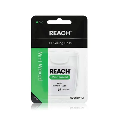 Shows the REACH mint waxed dental floss in its retail packaging to communicate the brand, product type, flavor, and quantity to the shopper. Displays the physical retail packaging the buyer will…