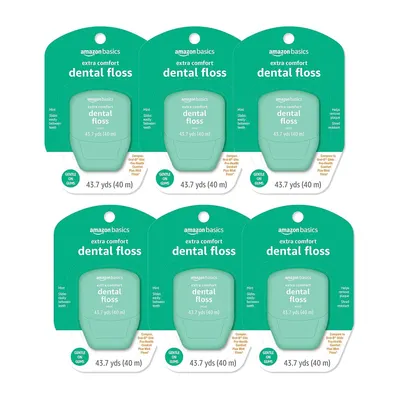 Shows the core sellable product—Amazon Basics extra comfort dental floss in mint flavor—displayed as a 6-pack to communicate quantity and value to the shopper. Displays the actual retail packaging…
