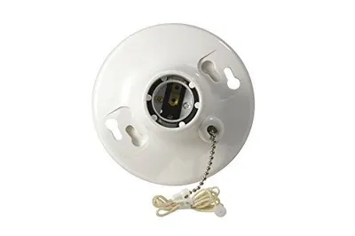 Shows the core product clearly on a white background, allowing shoppers to see the ceramic light socket fixture with mounting keyhole slots and pull chain switch. Uses a subtle drop shadow beneath…