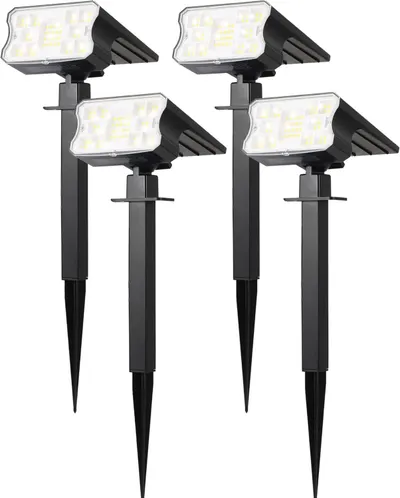 Shows the core product as a set of four solar-powered LED outdoor lights with adjustable heads and ground stakes, clearly displaying what the buyer will receive. Displays multiple units side-by-side…