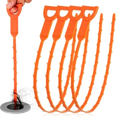 Demonstrates how the product works by showing it in action removing hair from a drain, communicating its primary function and effectiveness. Shows a human hand holding and using the product to…