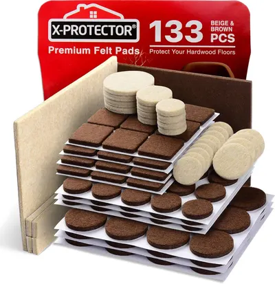 Displays the complete 133-piece felt pad set with various shapes (round, square, rectangular) and sizes in beige and brown colors to show shoppers the full variety and quantity included in the…