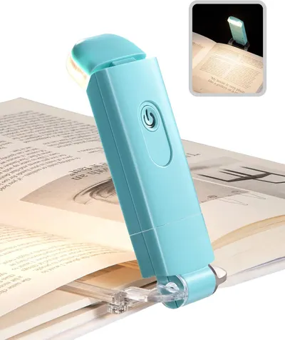 Shows the core product—a portable clip-on reading light—clearly displayed in use on a book to communicate its primary function and design. Demonstrates the product actively lighting up book pages…
