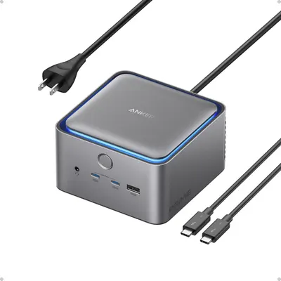 Shows the core product, an Anker hub/docking station, with its sleek metallic design and blue LED accent to communicate quality and modern aesthetics. Displays the included accessories (power cord…