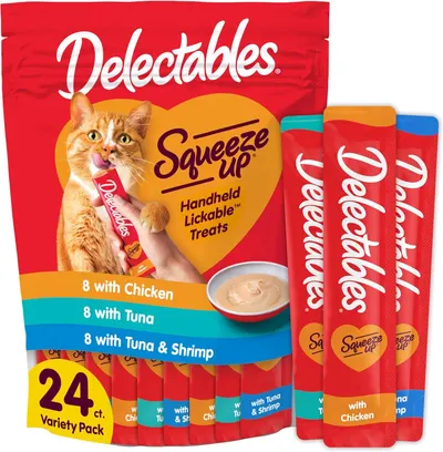 Shows the core product packaging and individual treat tubes to communicate what the shopper will receive—a 24-count variety pack of handheld, lickable cat…