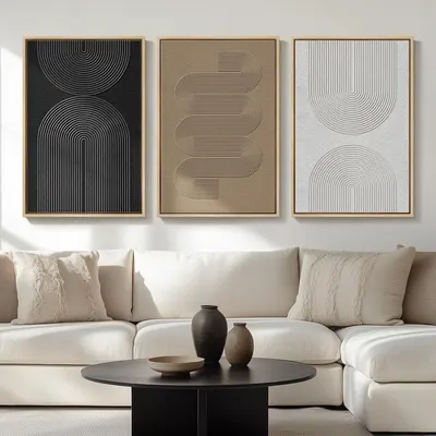 Shows the wall art set displayed in a styled living room environment to help shoppers visualize how the product will look in their own home and understand its…