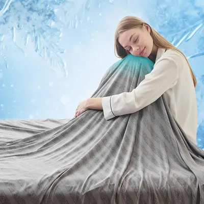Shows a person using the blanket to demonstrate its size, softness, and comfort, helping shoppers visualize how the product feels and fits in real use. Uses a decorative winter-themed background…
