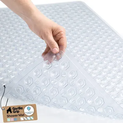 Shows a human hand interacting with the shower mat to demonstrate its size, texture, and ease of handling, helping shoppers understand the product's real-world scale and tactile quality.…