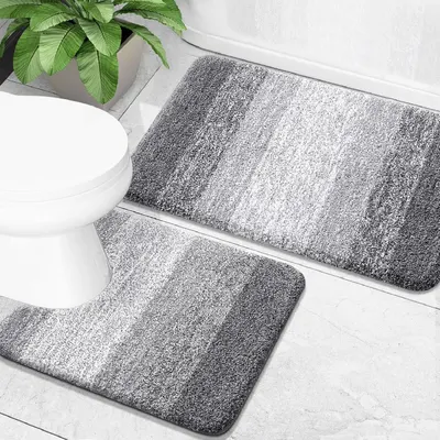 Shows the core product—a two-piece bathroom mat set with a contoured toilet mat and rectangular mat—displayed in a realistic bathroom setting to help shoppers…