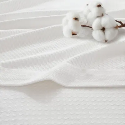 Showcases the product's soft, natural cotton fabric with a lifestyle prop (cotton plant) to emphasize the premium, natural material quality and softness of…