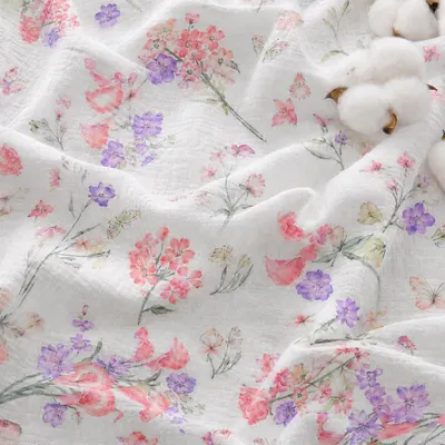 Showcases the product's delicate floral pattern and soft, draped fabric texture to communicate its aesthetic appeal and quality for home textiles or bedding. Presents the fabric in a styled, natural…
