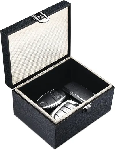 Shows the core product—a storage box designed to organize and protect car key fobs—displayed open to reveal its interior and contents. Demonstrates how the box functions as a secure storage solution…