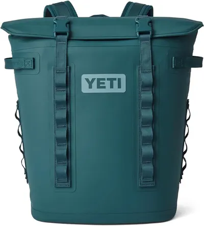 Displays the core YETI backpack cooler product in a clean catalog style, allowing shoppers to clearly see the design, roll-top closure, straps, and branding.