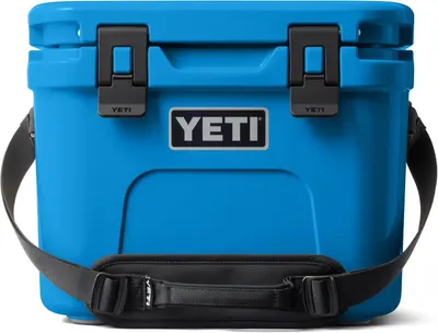 Displays the YETI cooler as the core product with its distinctive blue color, robust construction, secure latches, and carrying strap to communicate…