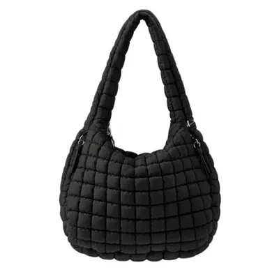 Shows the core black quilted shoulder bag on a clean background so shoppers can see its full shape and puffy quilted texture. Presents the bag with a plain grounded look that makes the bold black…
