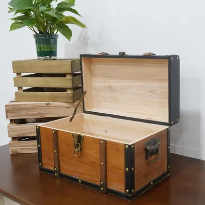 Shows the core wooden trunk with its interior and lid open so shoppers can see the build quality and storage space. Places the trunk in a real room setting on a wooden table to suggest how it fits…