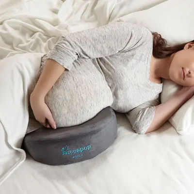 Shows a person resting against the pillow in bed so shoppers can see how it supports the body during sleep. Places the pillow in a real bedroom environment to convey comfort and everyday use at home.