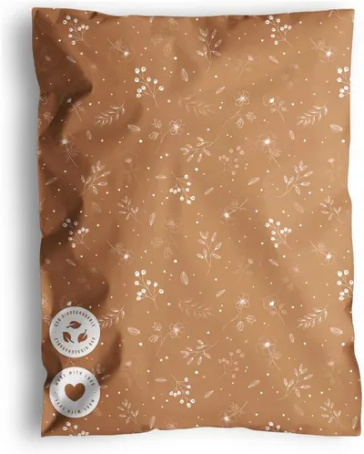 Shows the core mailer bag as the single sellable item with its botanical print so shoppers can see the design and material. The soft shadow and warm tan surface ground the bag visually and give it a…