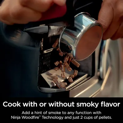 Highlights the ability to add a smoky flavor to cooking by using the Ninja Woodfire Technology and wood pellets.