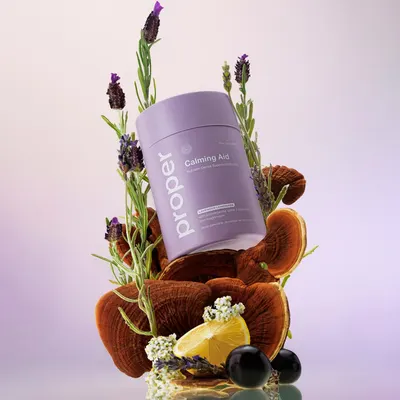 Highlights the calming and natural properties of the product using lavender flowers and other botanical elements.