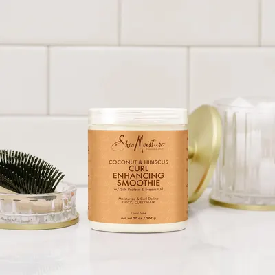 Highlights the product's ability to enhance and define curls while providing moisturization for thick, curly hair.