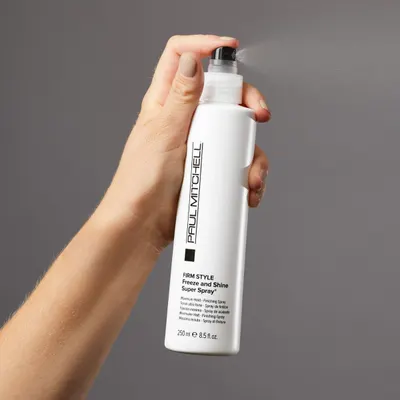Highlights the product's ability to provide a firm, maximum hold for hairstyling with its finishing spray.
