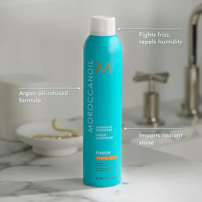 Highlights multiple benefits of the hairspray such as fighting frizz, repelling humidity, containing argan oil, and providing radiant shine.