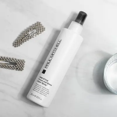 Highlights the product's ability to provide a firm, long-lasting hold with a shiny finish for styled hair.