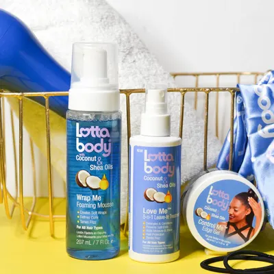Shows the different hair care products included in the Lottabody Coconut & Shea Oils line, such as the Wrap Me Foaming Mousse, Love Me Leave-In Treatment, and…