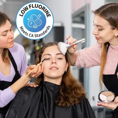 Showcases the product being used in a realistic salon setting by professionals, providing a relatable and authentic use case.