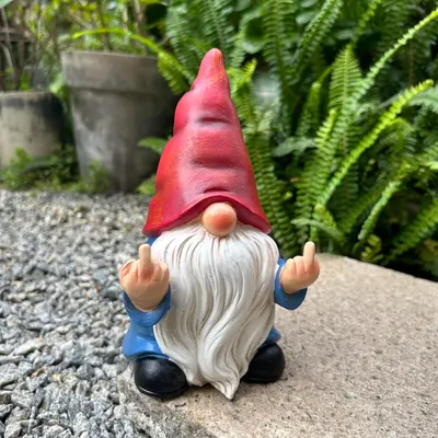 Shows the product in a realistic outdoor setting to demonstrate its use as a decorative garden ornament.