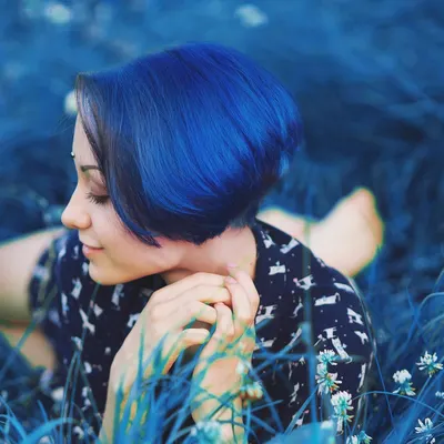 Showcases the vivid blue hair color result in a natural, outdoor setting to demonstrate the product's effectiveness and appeal.
